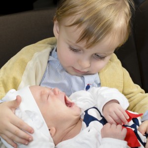 Curious Boy holding his little brother